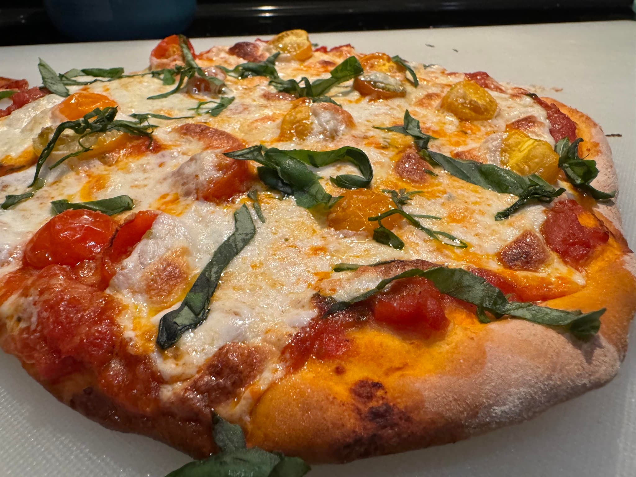 Gourmet margherita-style pizza prepared for casual event service.